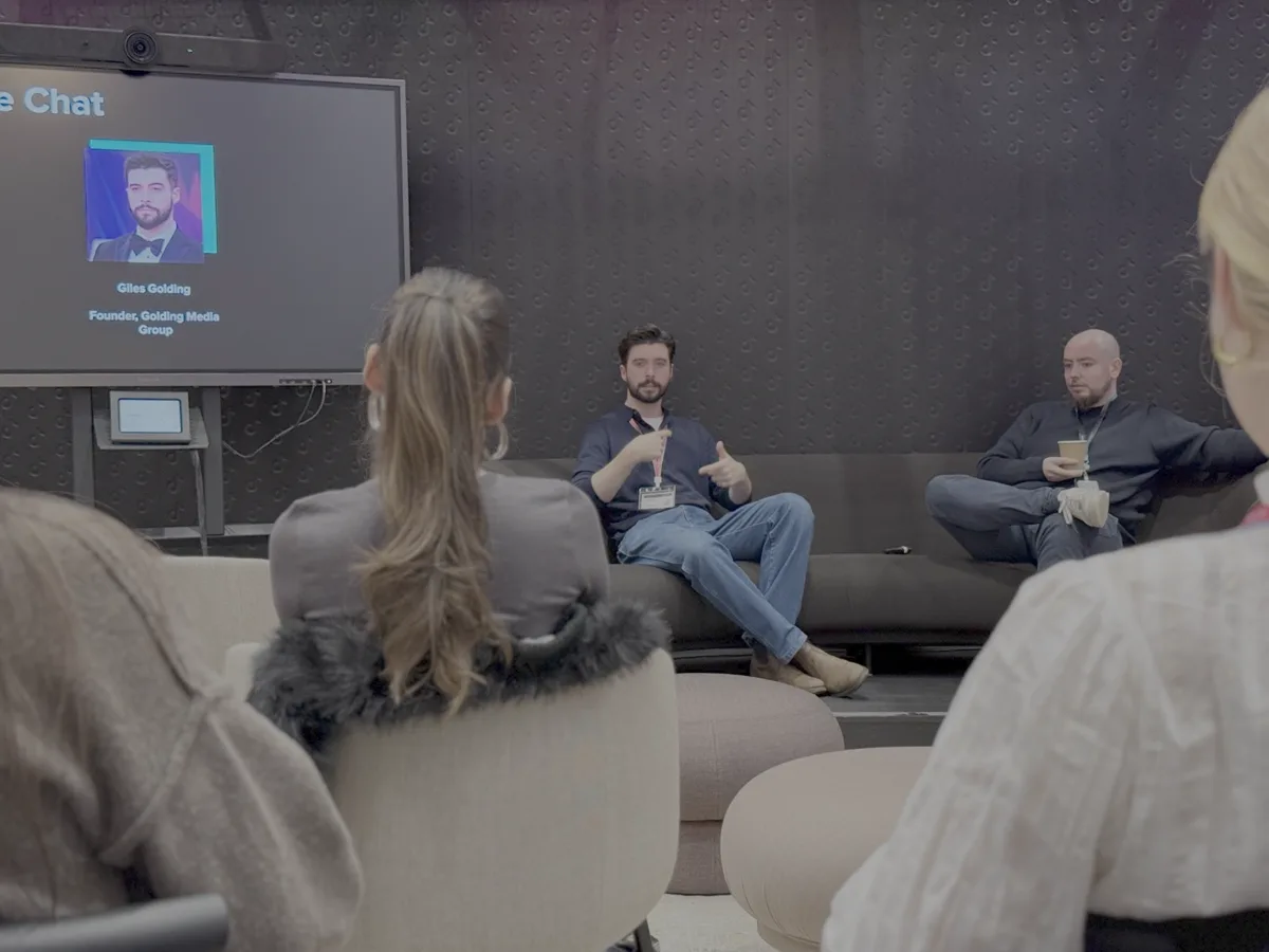 Close-up of Giles Golding speaking at TikTok's Fireside Chat with presentation slide showing Founder, Golding Media Group