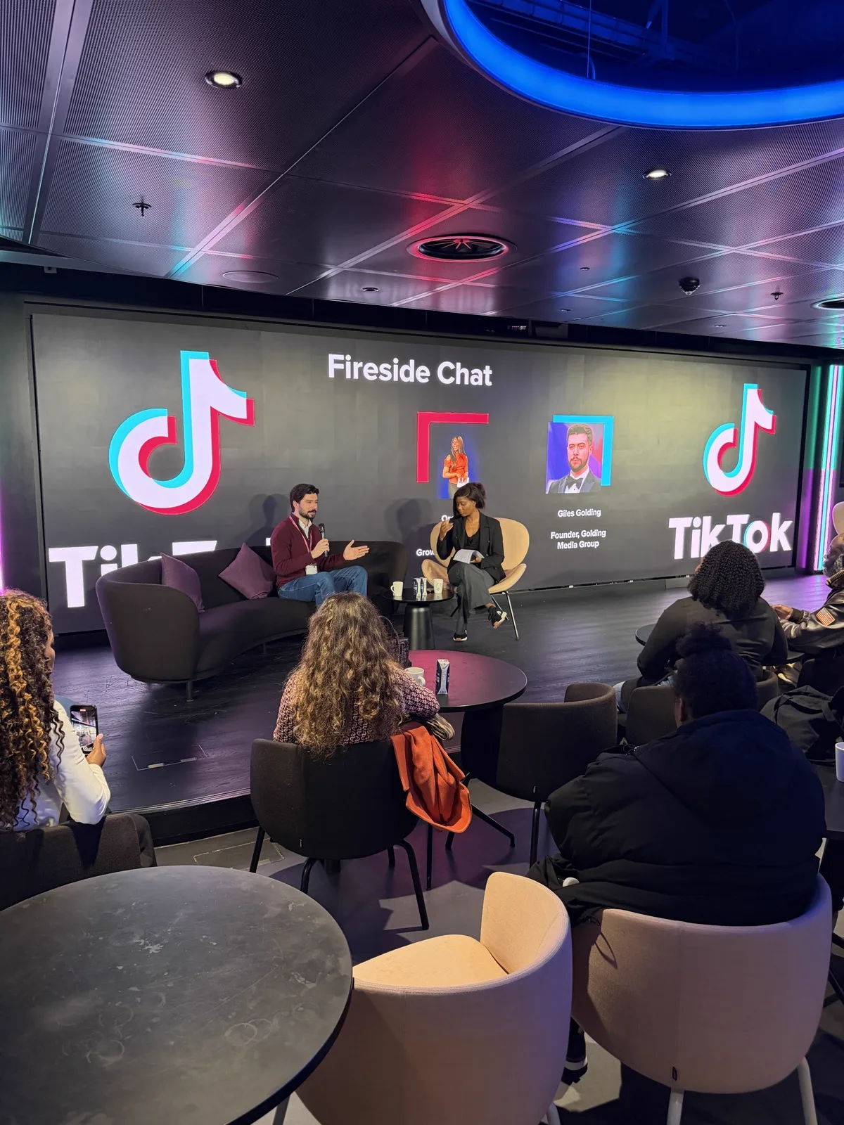 Giles Golding presenting GMG's Fireside Chat at TikTok HQ London, with TikTok branding and audience visible